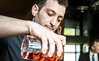 Bartender mixing cocktails at Kimpton Hotel Wilshire roof top deck space